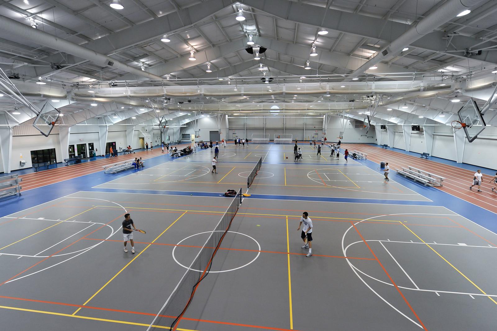 Students playing tennis in the Rec Center