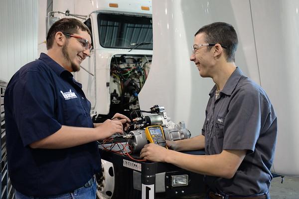 Two engineering students working with tools