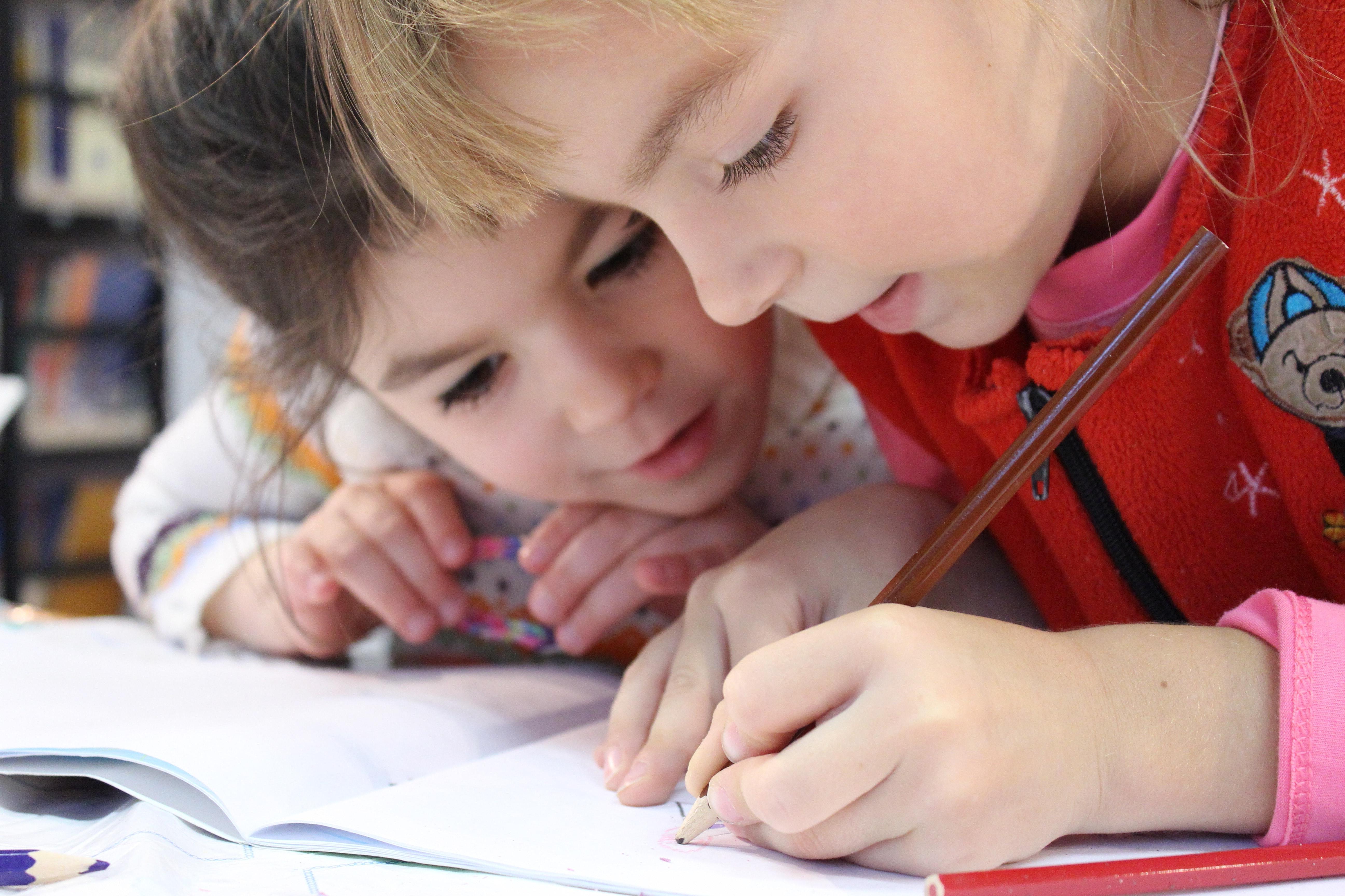 Two children working together to complete their homework